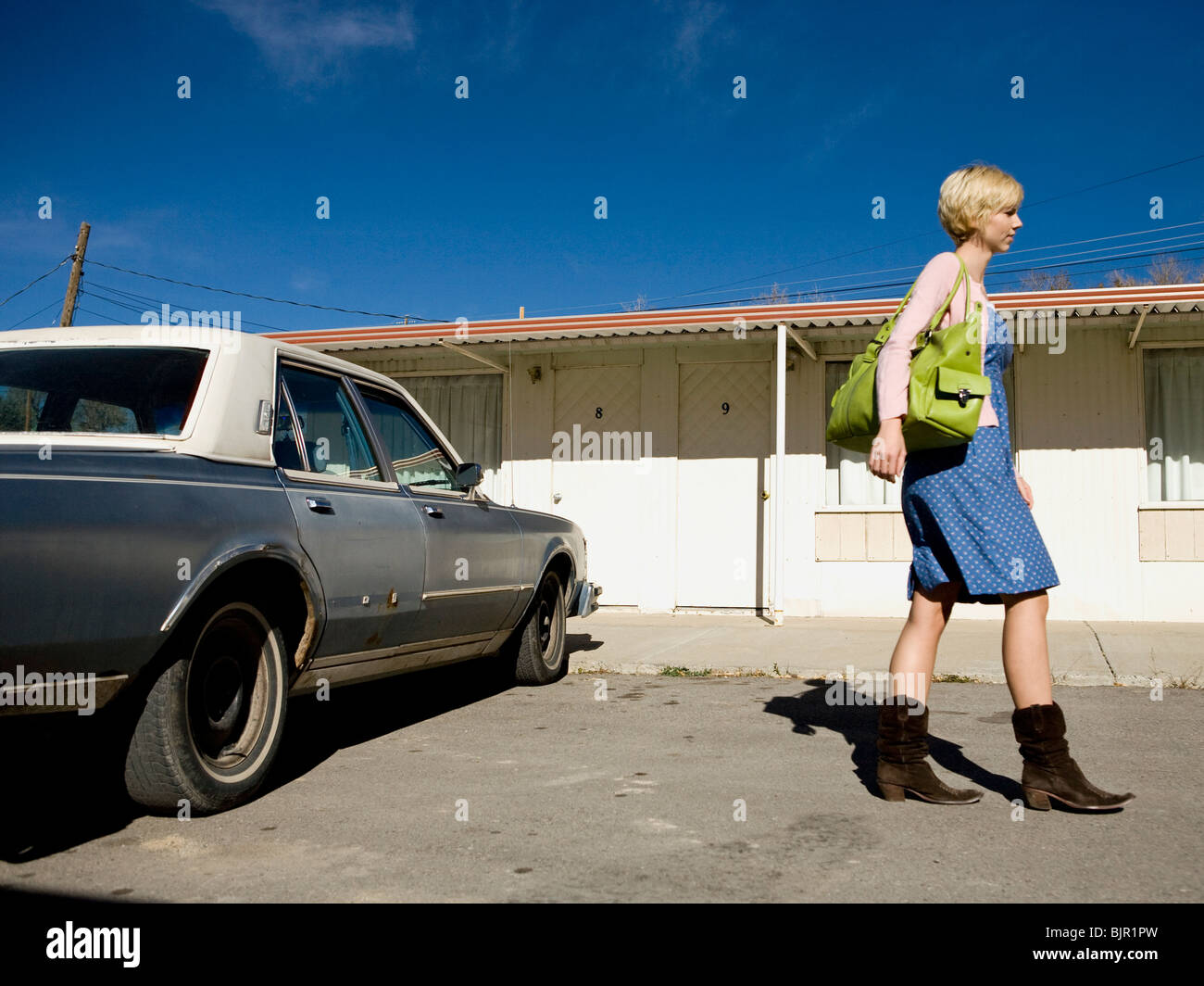 woman getting into an old car. Stock Photo