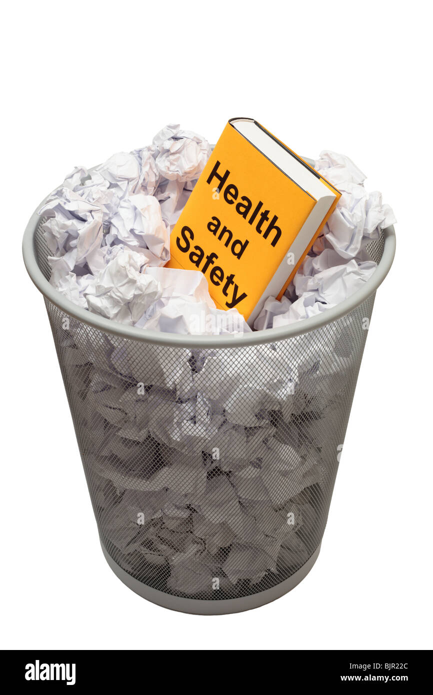 Book with words health and safety on cover in a bin full of paper Stock Photo