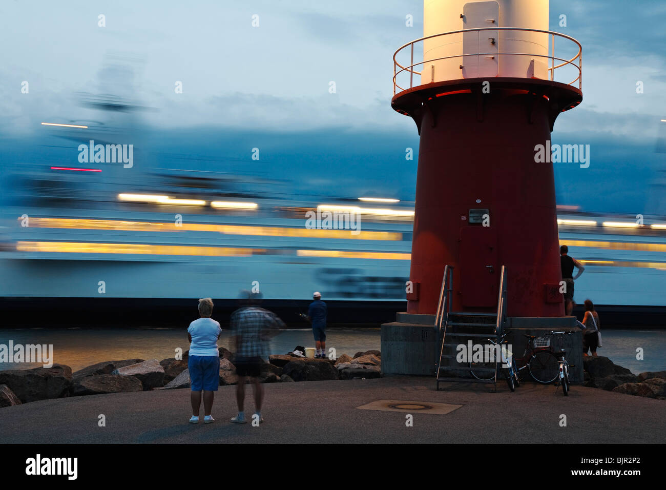 Incoming ferry at the Ostmole lighthouse, Warnemuende, Mecklenburg-West Pomerania, Germany, Europe Stock Photo