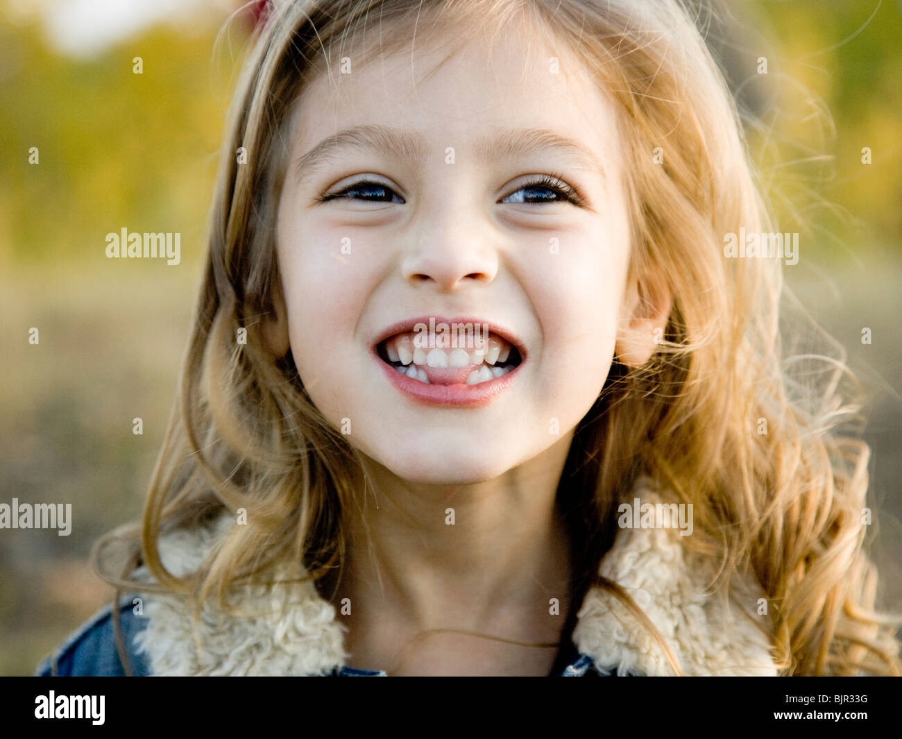 little girl putting her tongue through gap in teeth Stock Photo Alamy