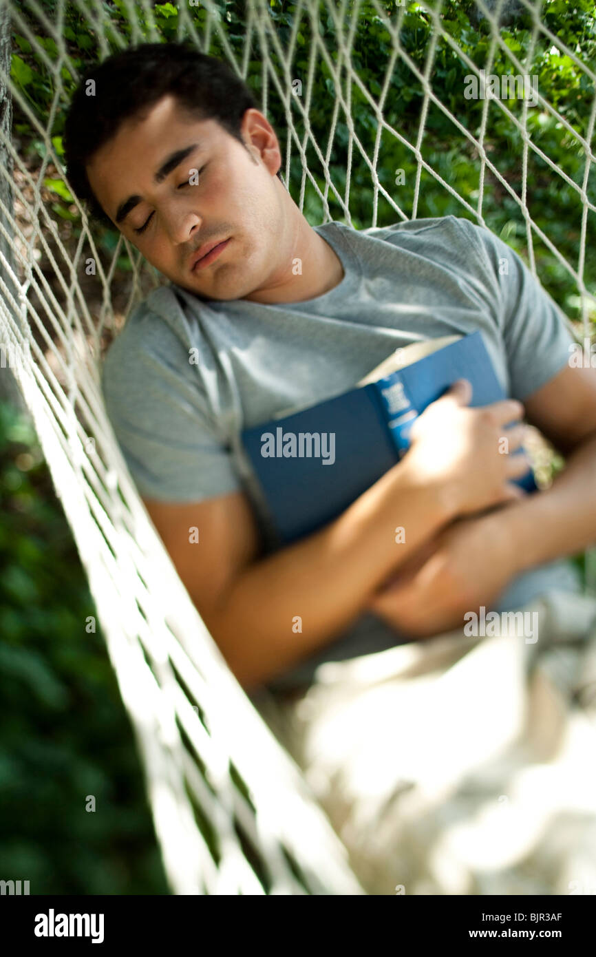 Man reading in a hammock Stock Photo - Alamy
