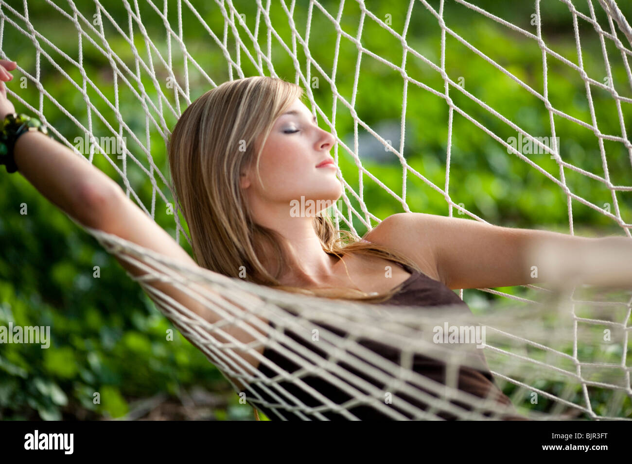Teenage girl in a hammock sleeping Stock Photo