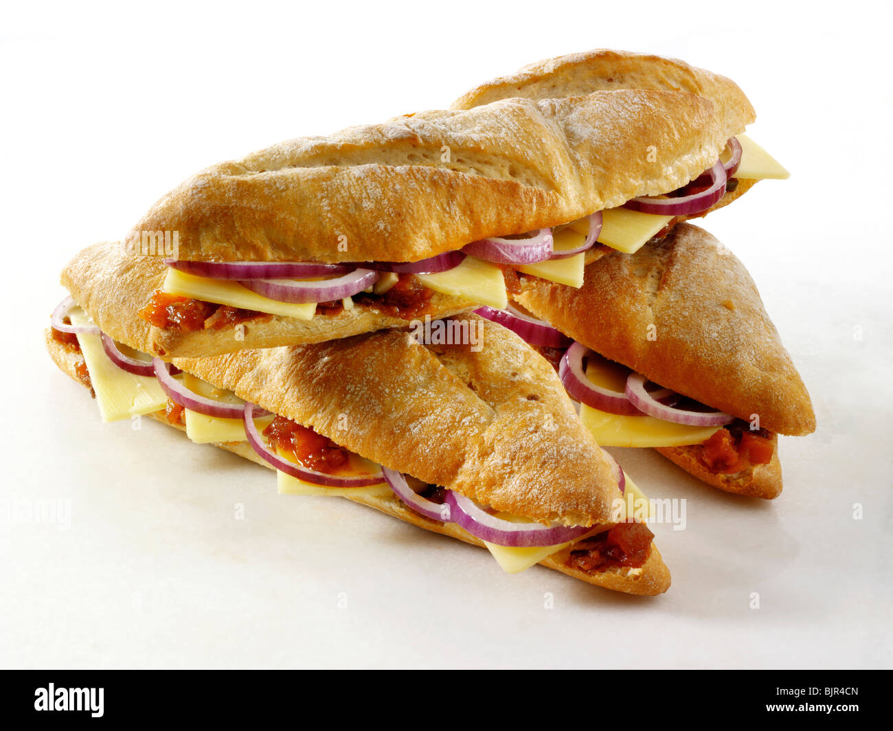 Ploughman's baguette, Cheddar cheese, red onion and pickle. Food photos. Stock Photo