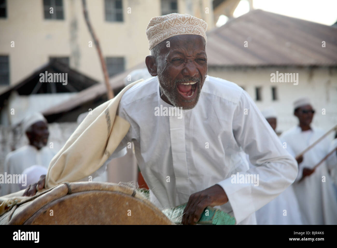 A man celebrating Maulidi outside Riyadha Mosque Lamu Kenya Stock Photo