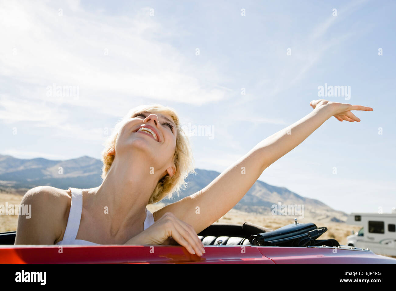 woman in a red convertible Stock Photo
