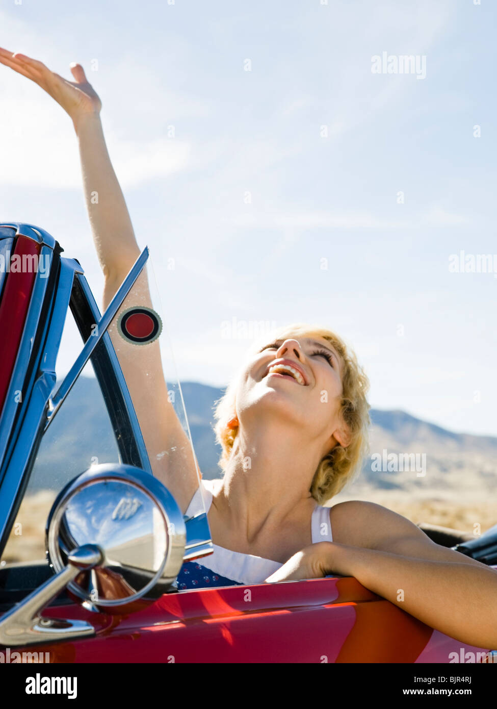 woman in a red convertible Stock Photo