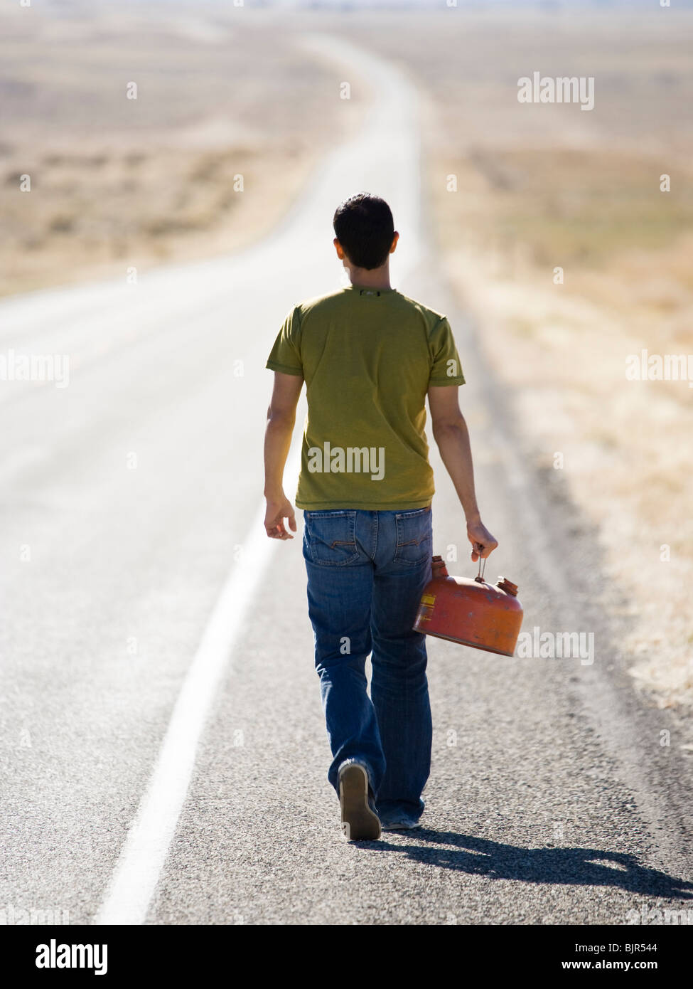 man walking with a gas can Stock Photo