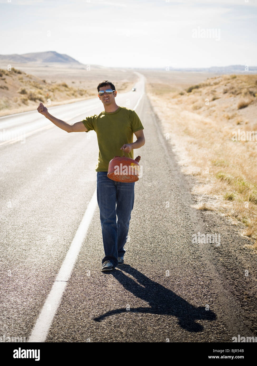 man walking with a gas can Stock Photo