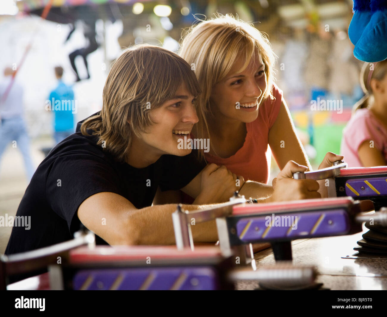 young couple at an amusement park Stock Photo - Alamy