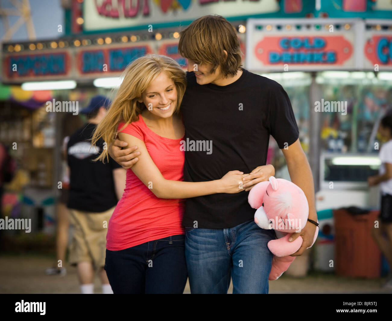 young couple at an amusement park Stock Photo