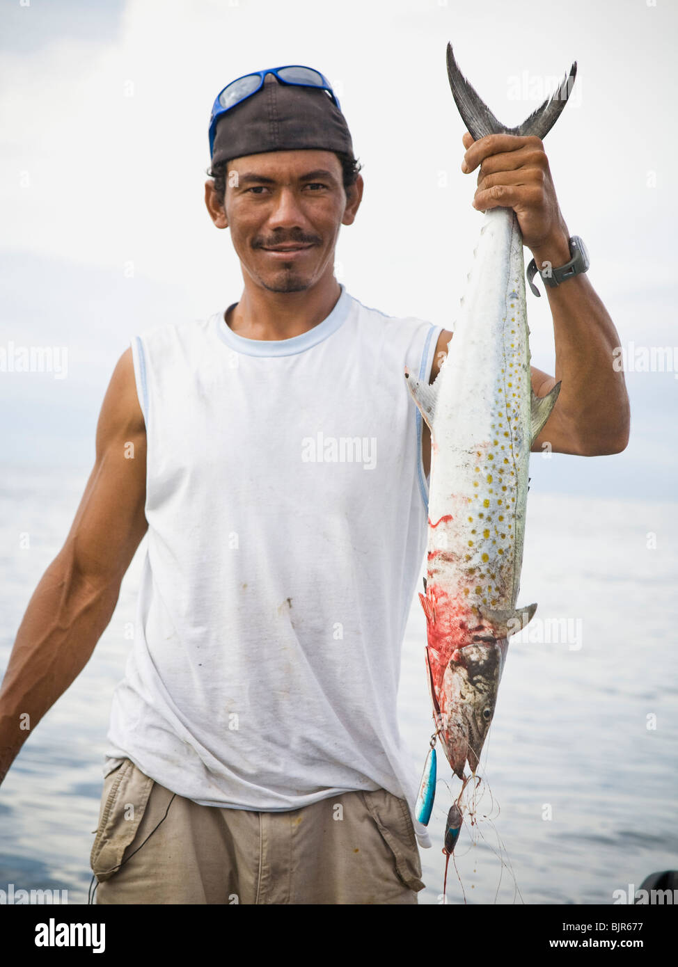 man holding a fish Stock Photo - Alamy