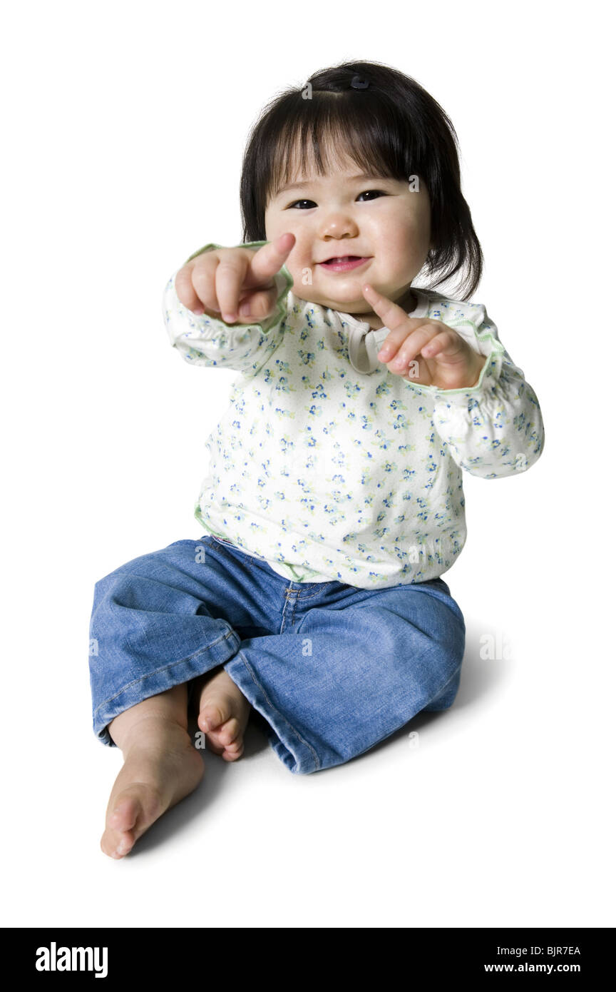 Little girl seated smiling Stock Photo