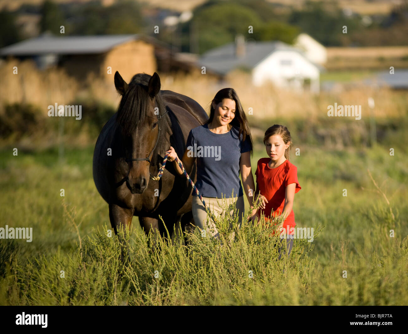woman, girl, and a horse Stock Photo
