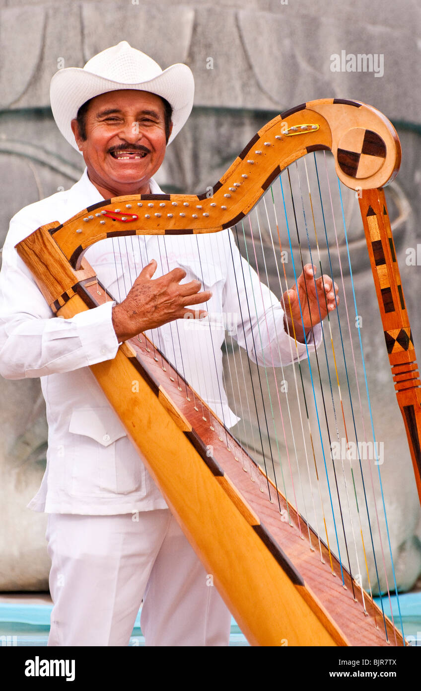 Playa del Carmen Mexico Happy harp musician playing the harp on
