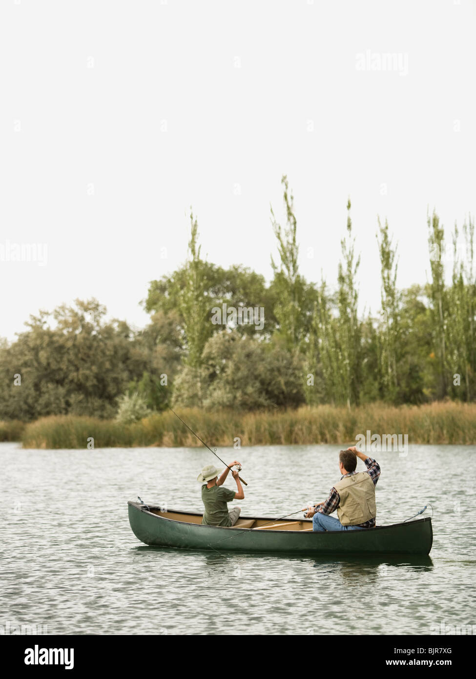 man and boy fishing on a lake Stock Photo