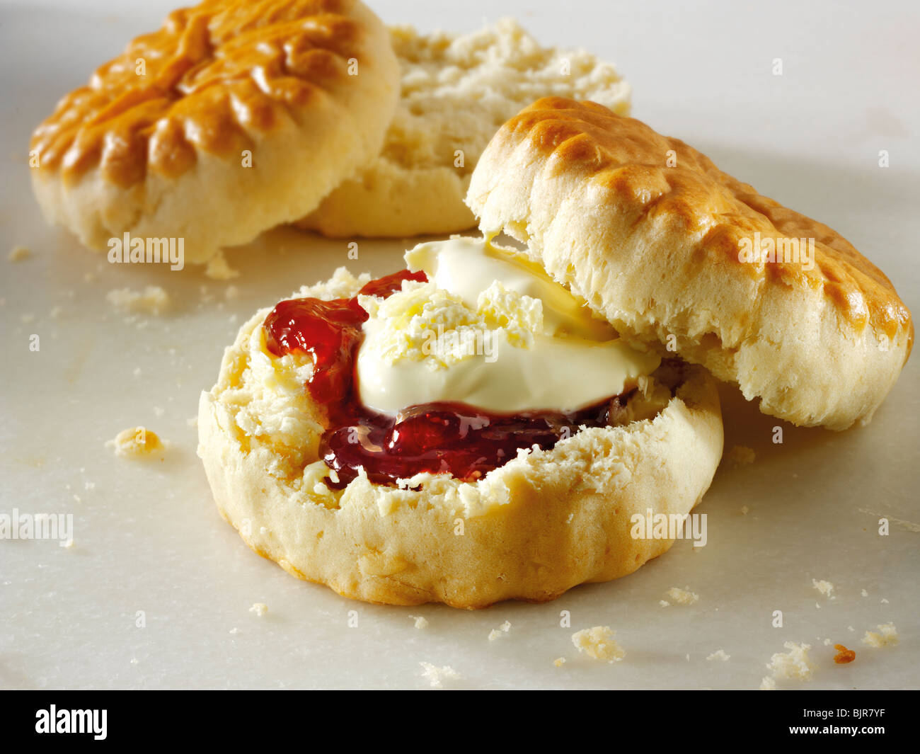 Traditional English scone with clotted cream and jam Stock Photo