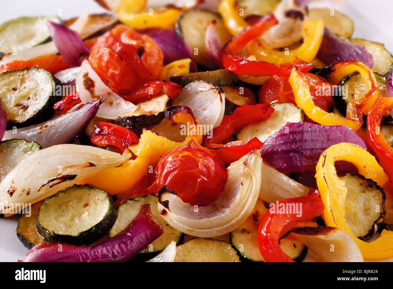 Mixed roast vegetables, onions, peppers and courgette food photos Stock