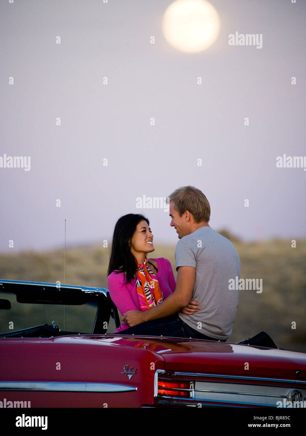 couple under a full moon Stock Photo - Alamy