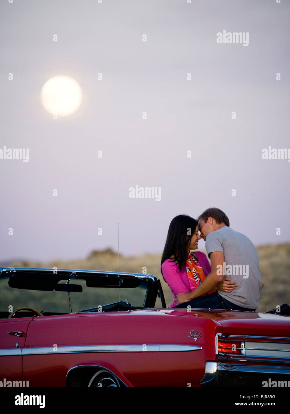 couple under a full moon Stock Photo - Alamy