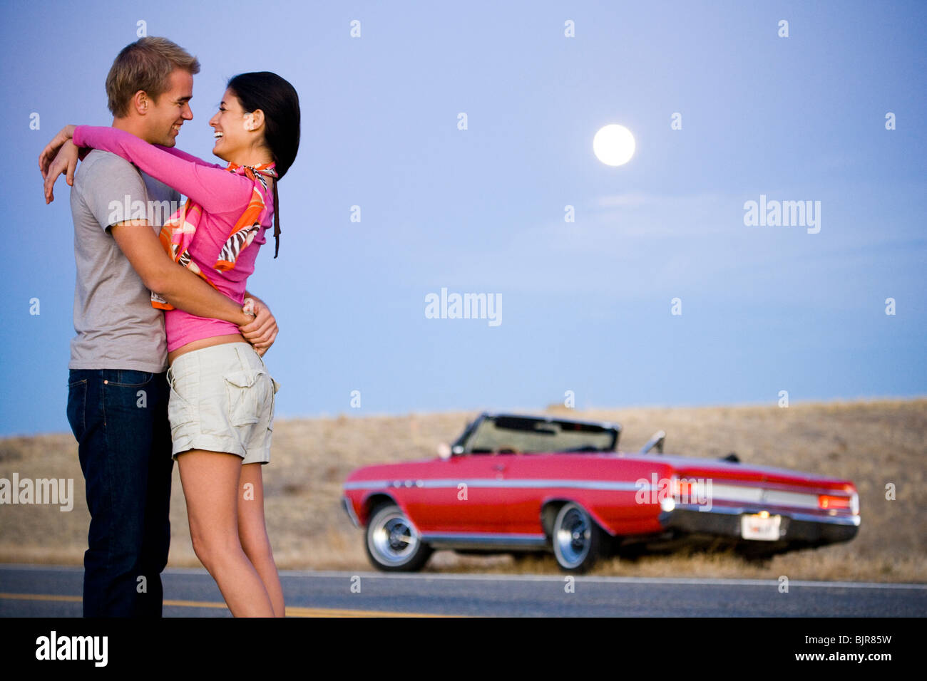 couple under a full moon Stock Photo - Alamy
