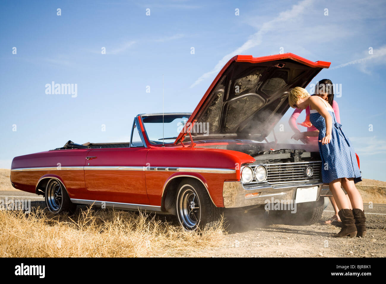 two women with a broken down car Stock Photo