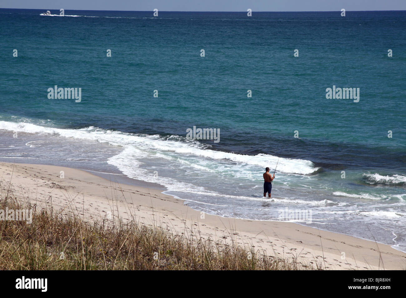 Lone man fishing in the distance, Palm Beach, FL, USA Stock Photo