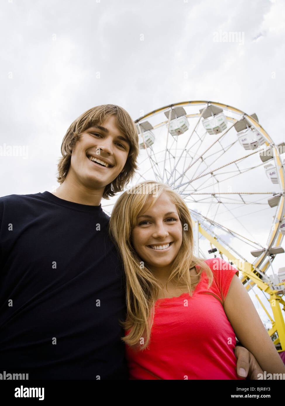 young couple at an amusement park Stock Photo