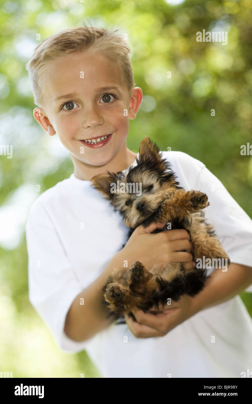 Boy holding small dog Stock Photo
