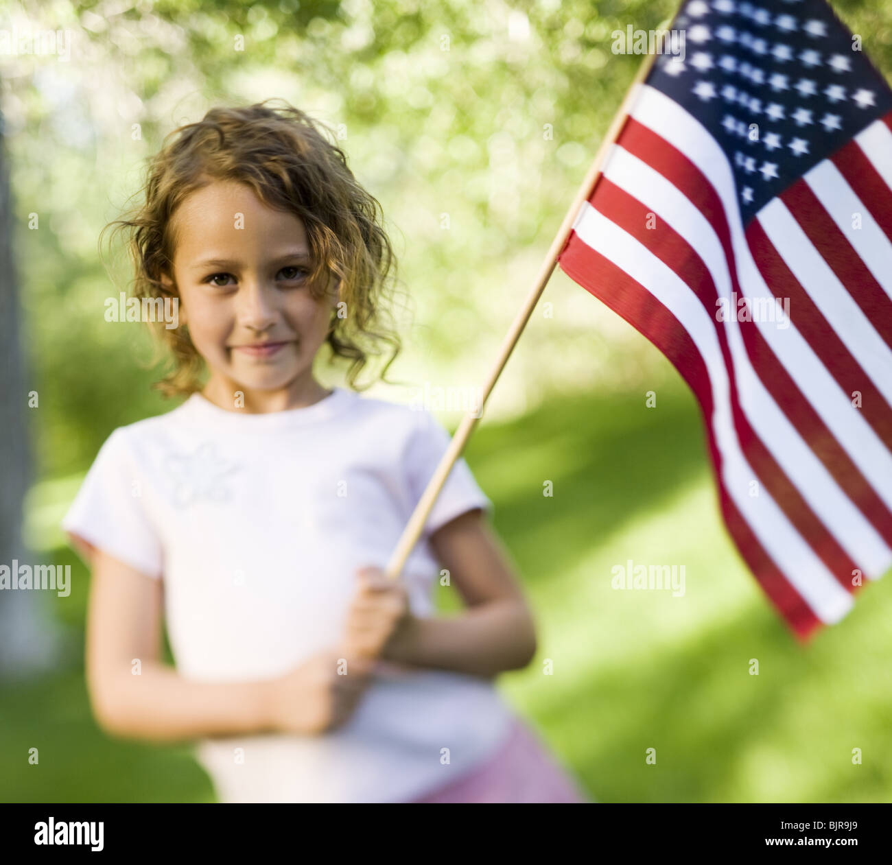 Girl holding US flag Stock Photo - Alamy