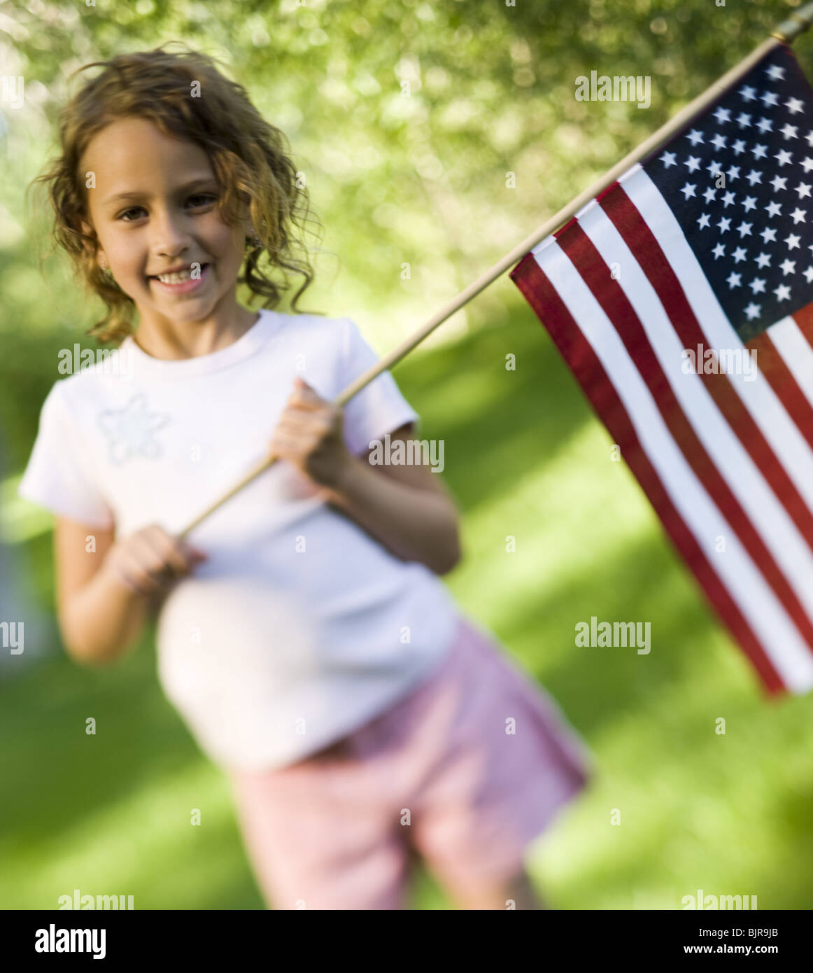 Girl holding US flag Stock Photo - Alamy