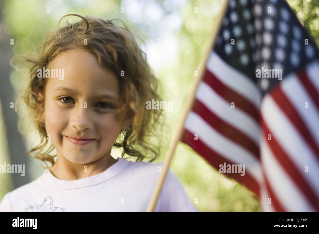 Girl holding US flag Stock Photo Alamy