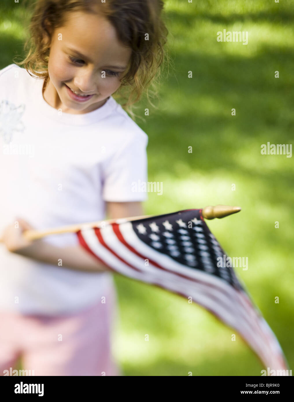 Girl holding US flag Stock Photo - Alamy