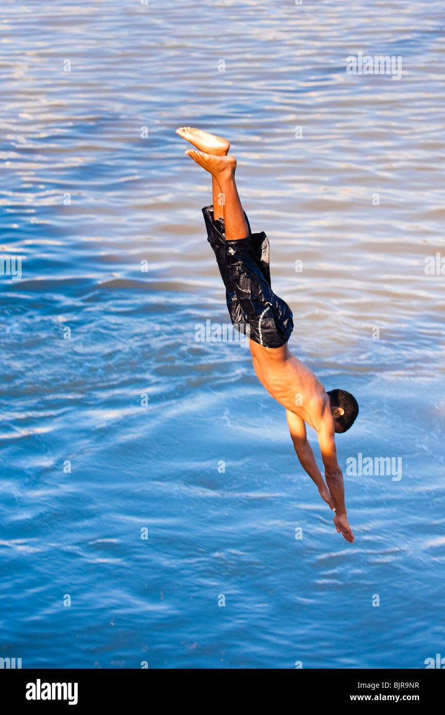 This is an image of a young man diving into the water Stock Photo Alamy