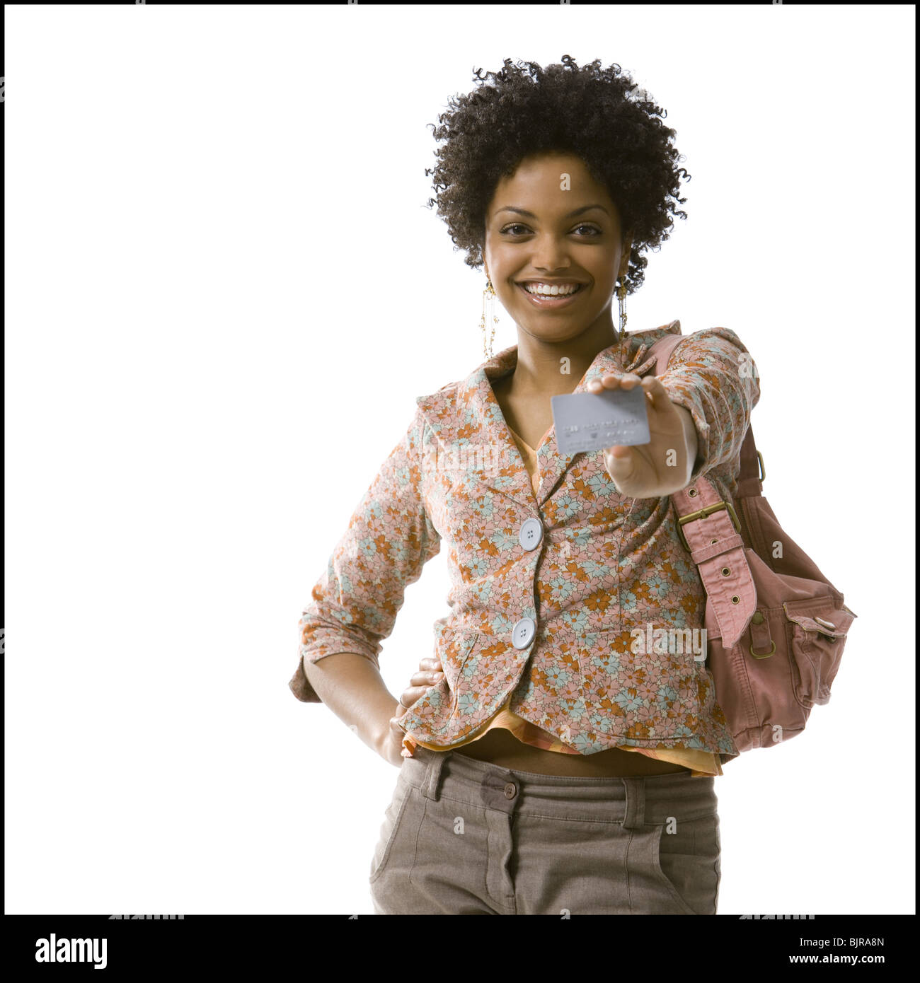 Woman posing and smiling with hand on hip Stock Photo - Alamy