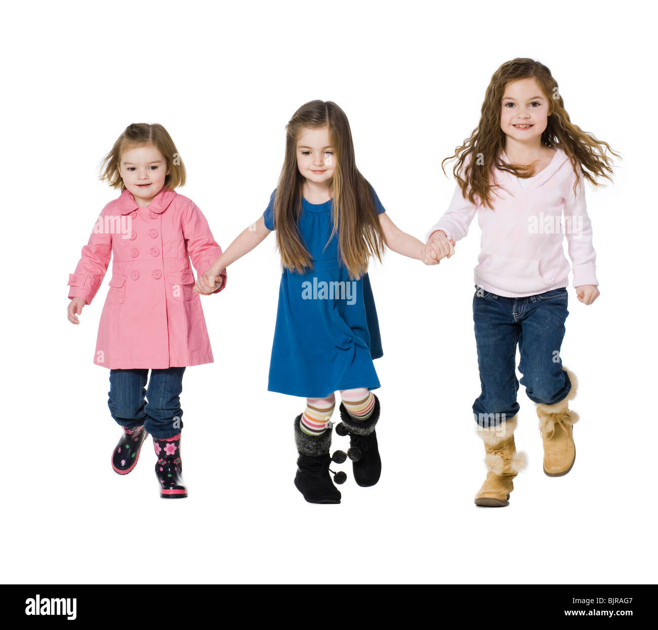 Studio portrait of three girls (2-7) holding hands Stock Photo - Alamy