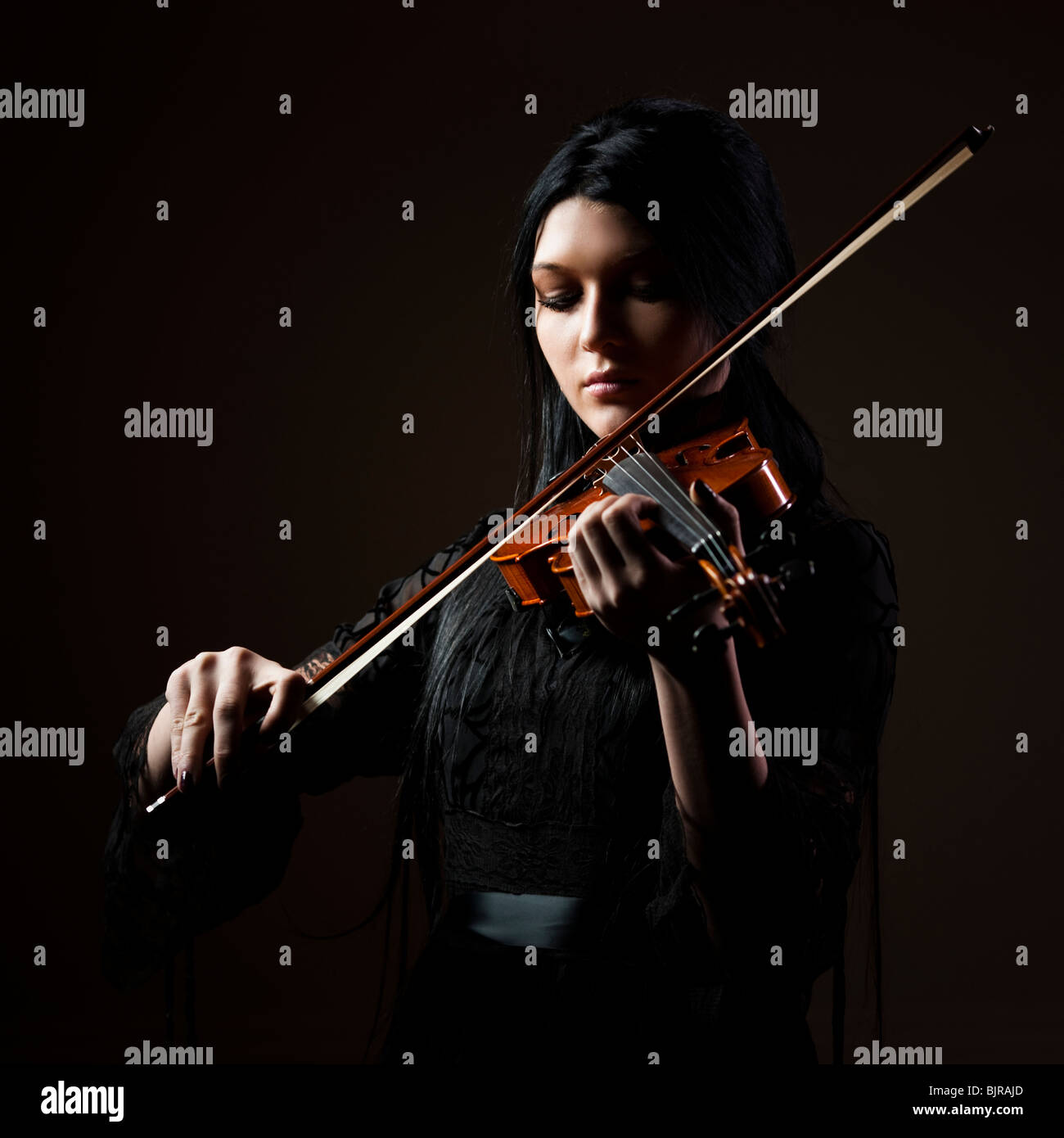 Young woman playing violin, studio shot Stock Photo