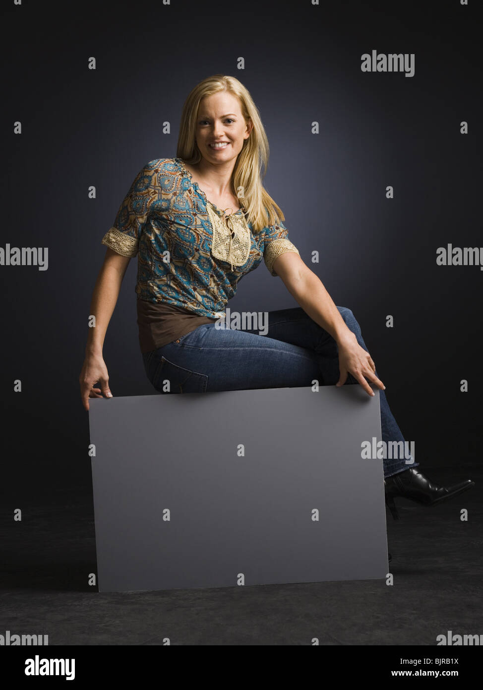 Smiling woman posing with back to the camera Stock Photo