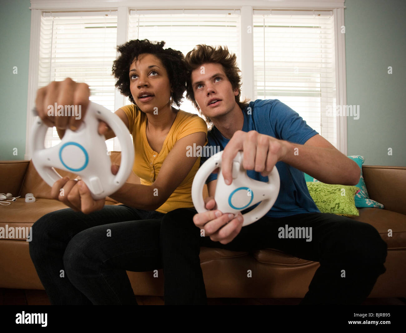 USA, Utah, Provo, young couple playing video games in living room Stock Photo