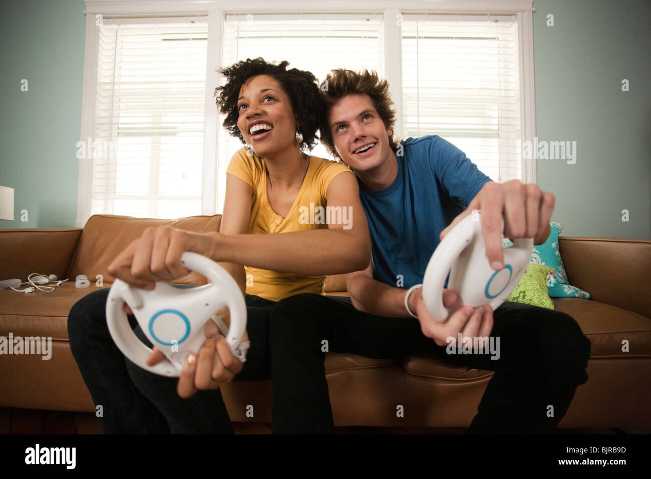 USA, Utah, Provo, young couple playing video games in living room Stock Photo