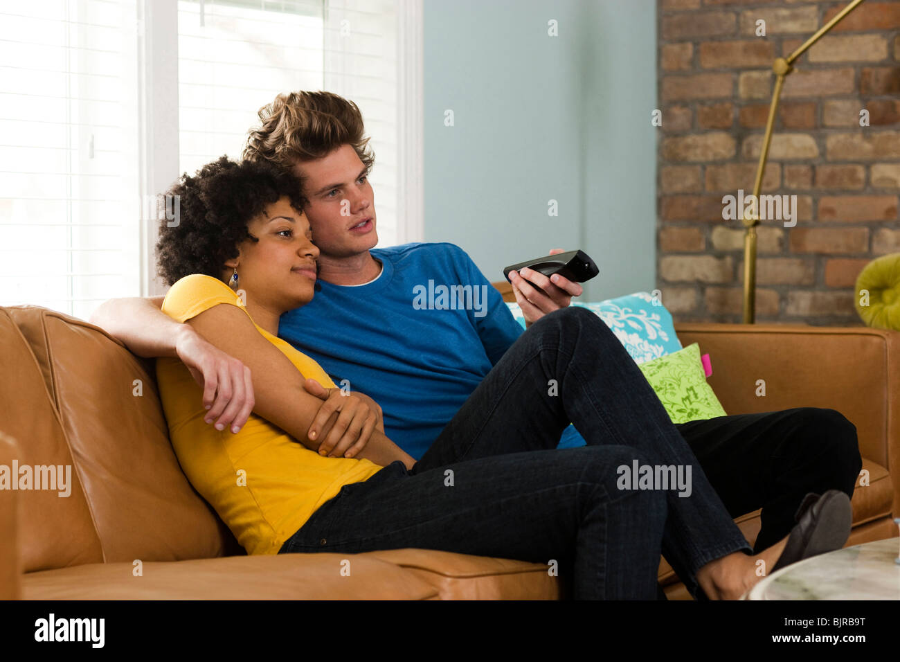 USA, Utah, Provo, young couple watching television in living room Stock Photo