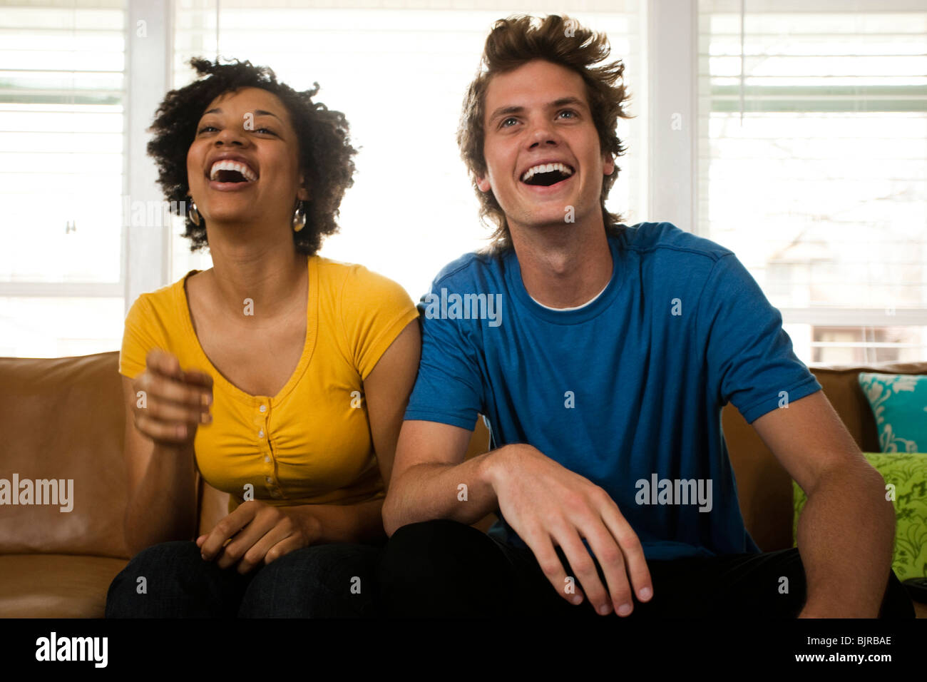 USA, Utah, Provo, young couple watching television in living room Stock Photo