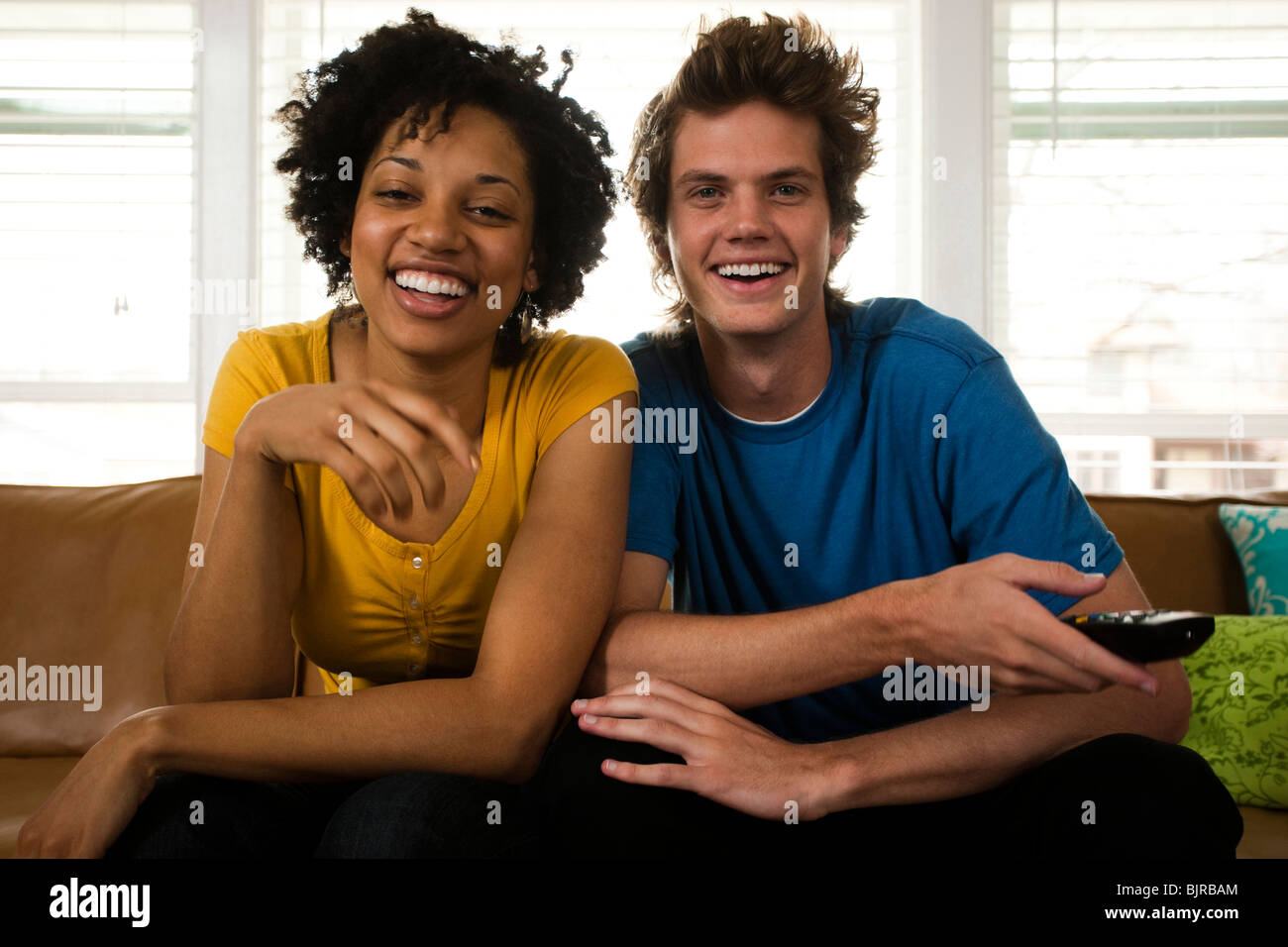 USA, Utah, Provo, young couple watching television in living room Stock Photo