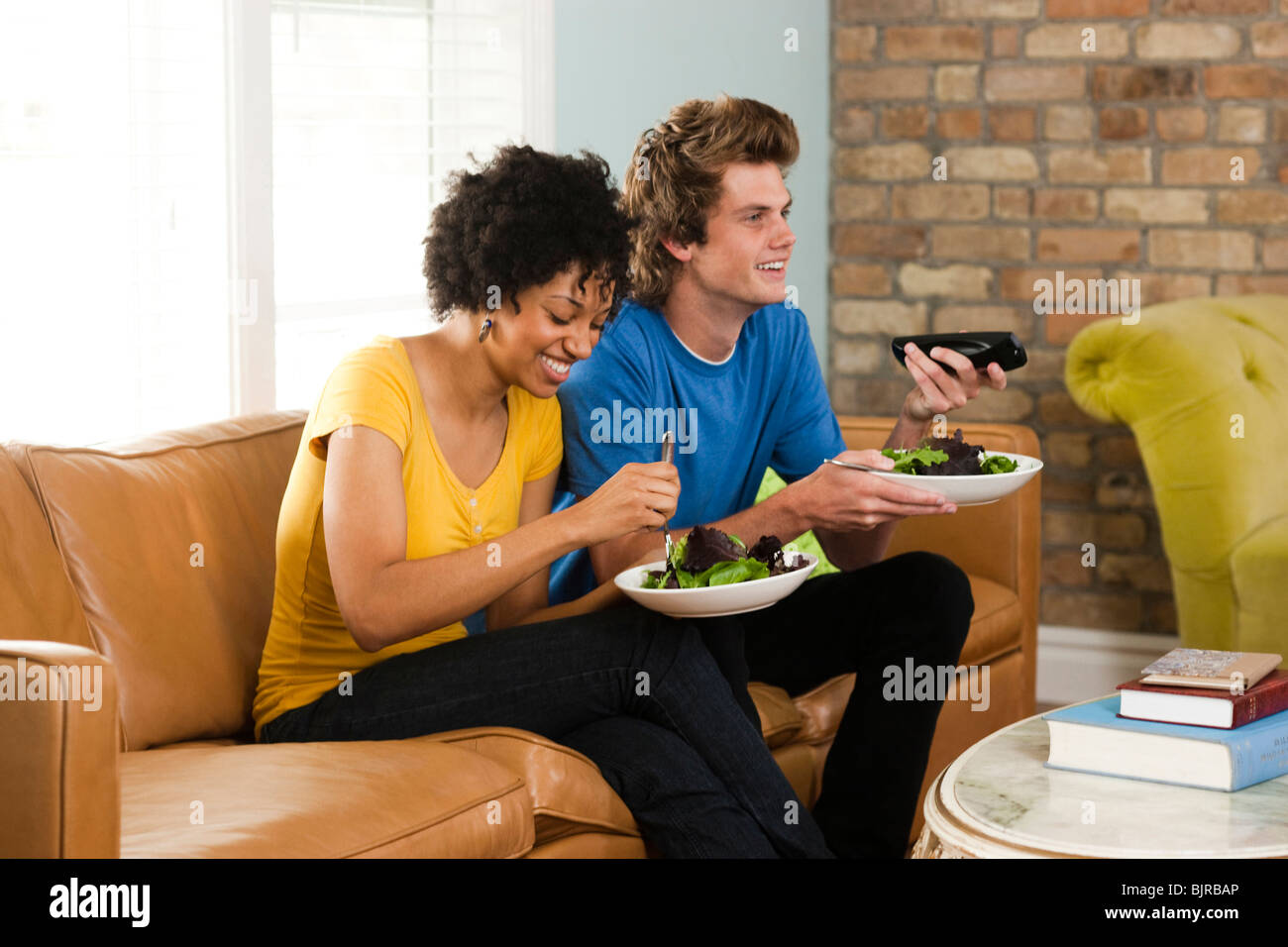 USA, Utah, Provo, young couple eating dinner, watching television Stock Photo