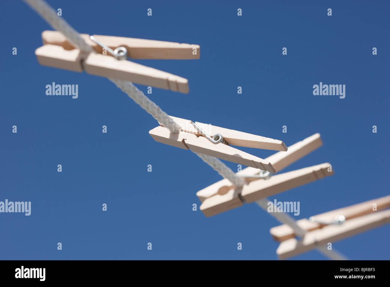 Clothes pegs hanging on washing line Stock Photo Alamy