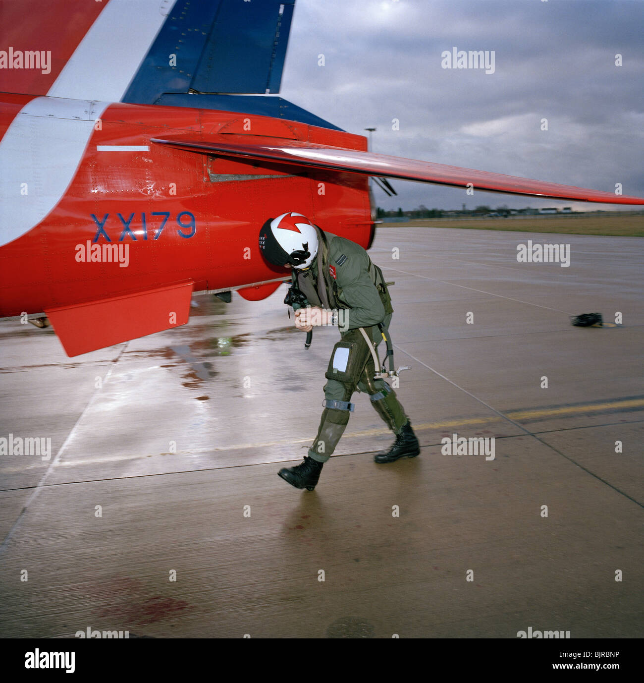 Red Arrows pilot Flt Lt. Si Stevens makes a pre-flight check of his Hawk jet aircraft before practice sortie above Lincolnshire. Stock Photo