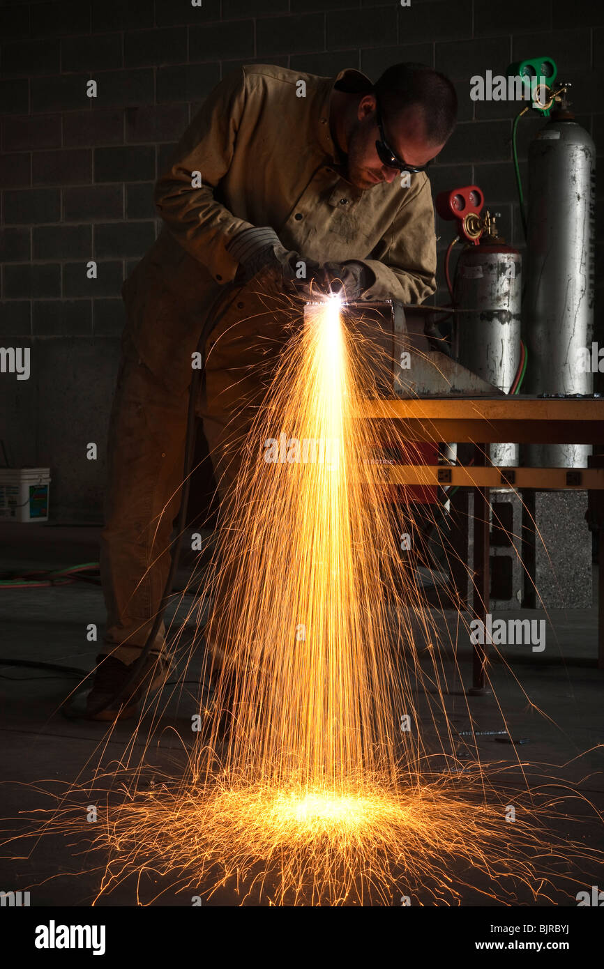 USA, Utah, Orem, man welding metal in workshop Stock Photo