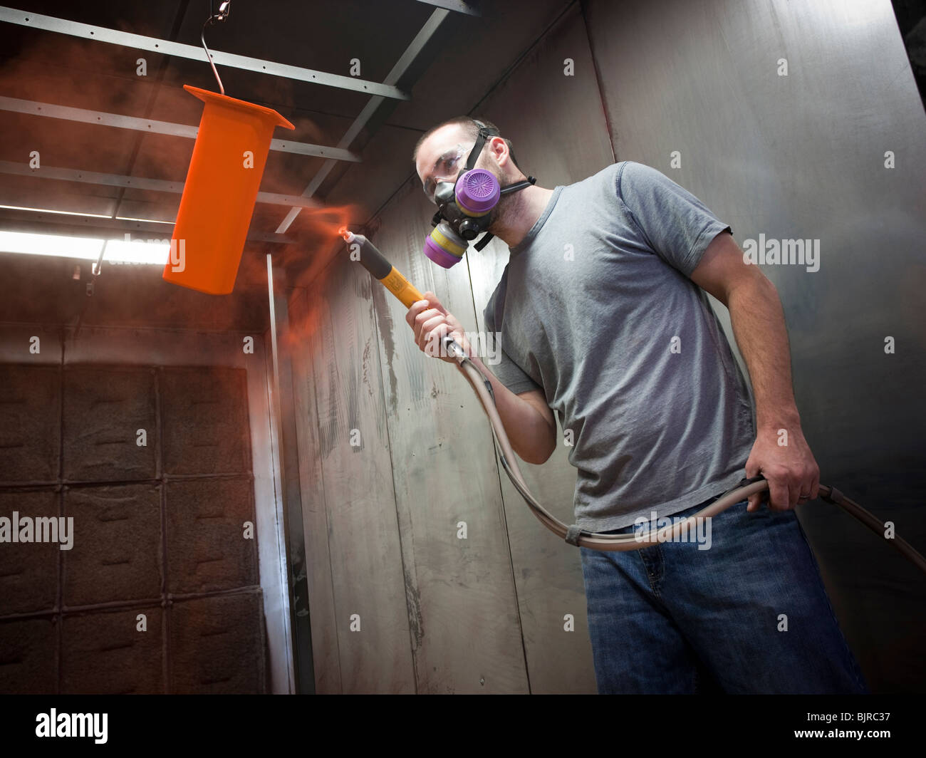 USA, Utah, Orem, man using paint spray gun Stock Photo