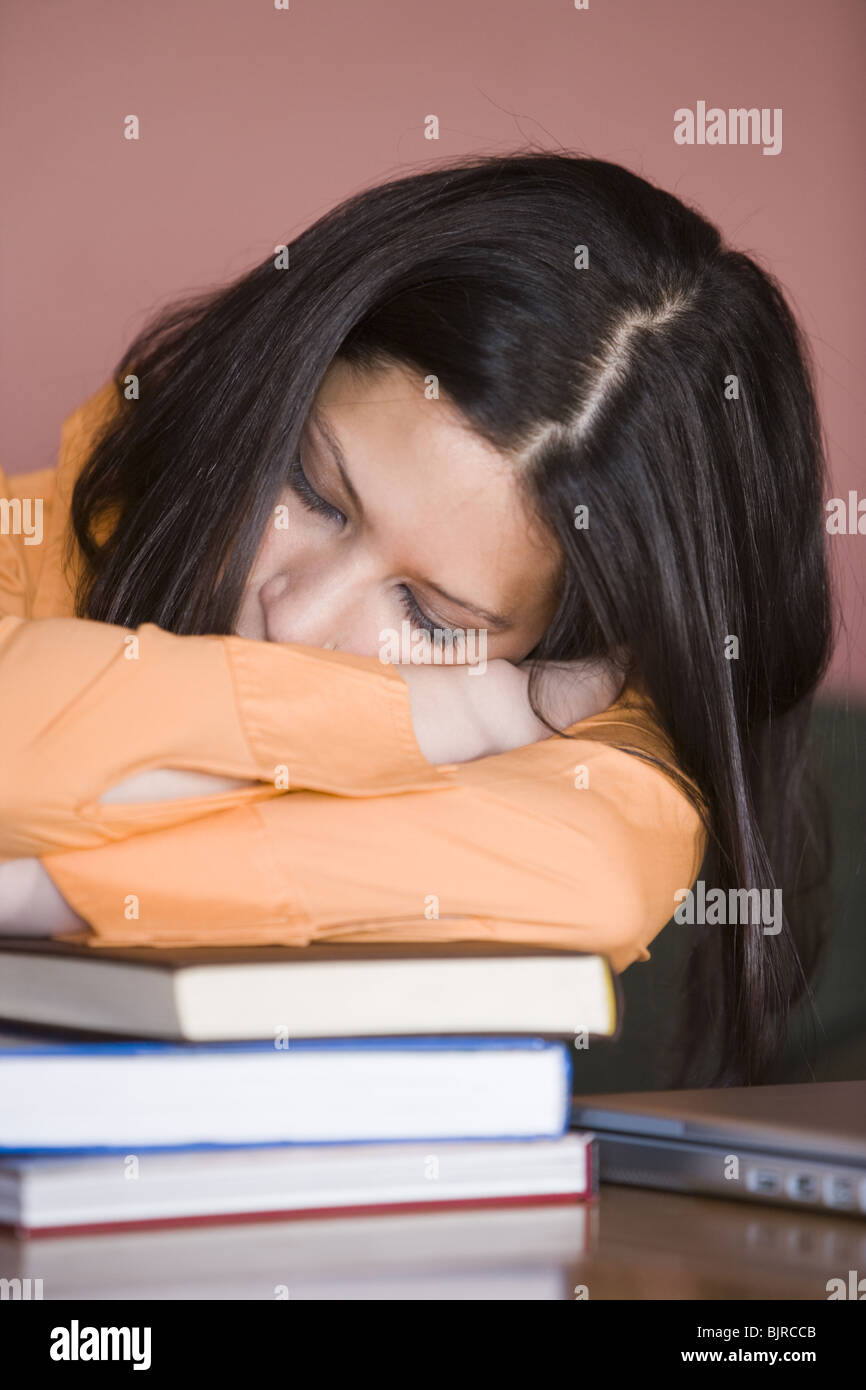 Student sleeping on stack of books Stock Photo - Alamy