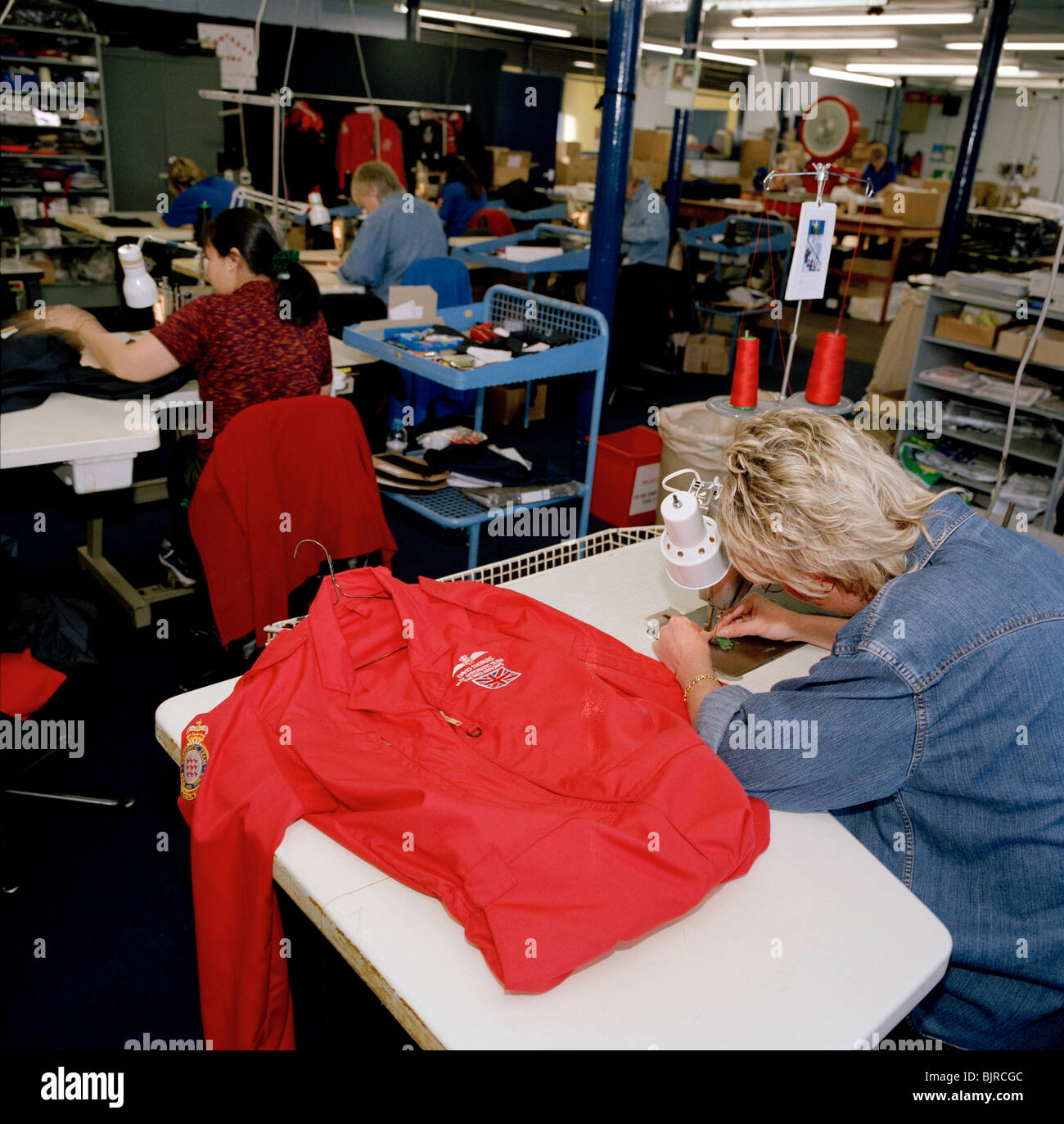 Senior Machinist Supervisor Tricia Randle finishes a red flying suit of Squadron Leader David Thomas, a pilot of the Red Arrows. Stock Photo