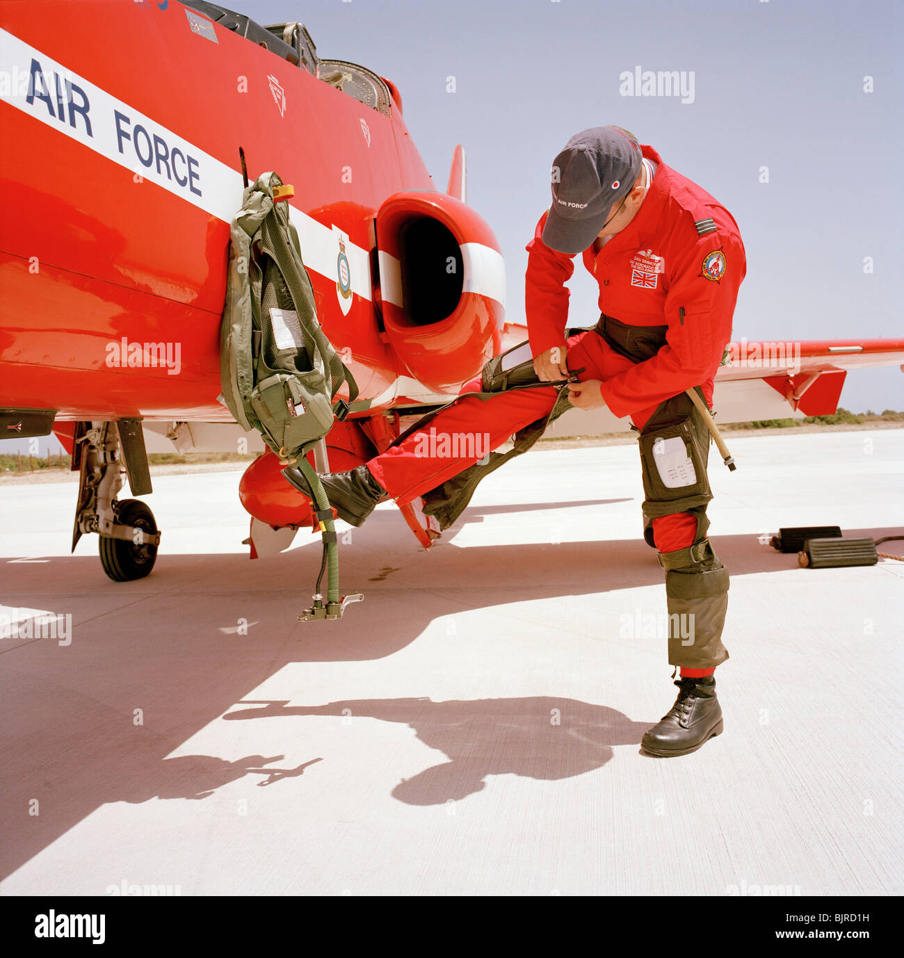 Red Arrows pilot Flight Lieutenant Dan Simmons zips into his g-pants before climbing into his Hawk jet. See also longer caption. Stock Photo